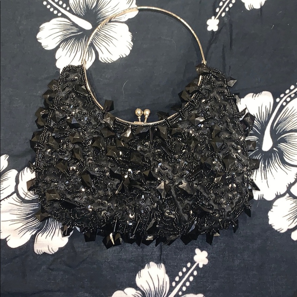 A black handbag with dangling rhinestones